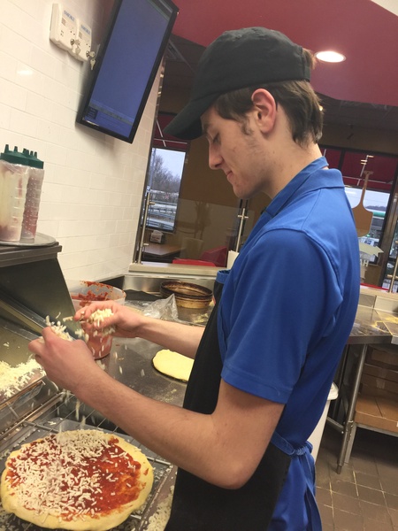 boy making pizza